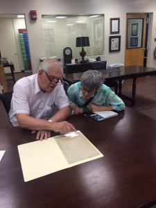 Assemblyman Steven Englebright and Maria Hoffman examining letter in Special Collections.
