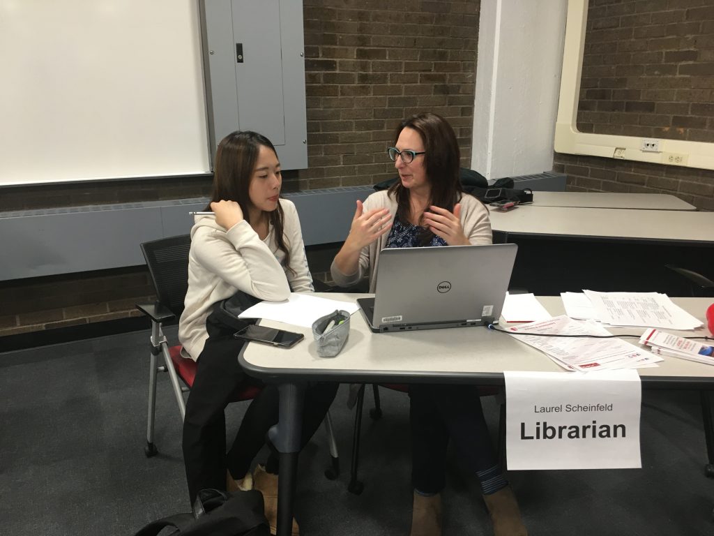 Laurel Scheinfeld helps a student find some sources for her paper.