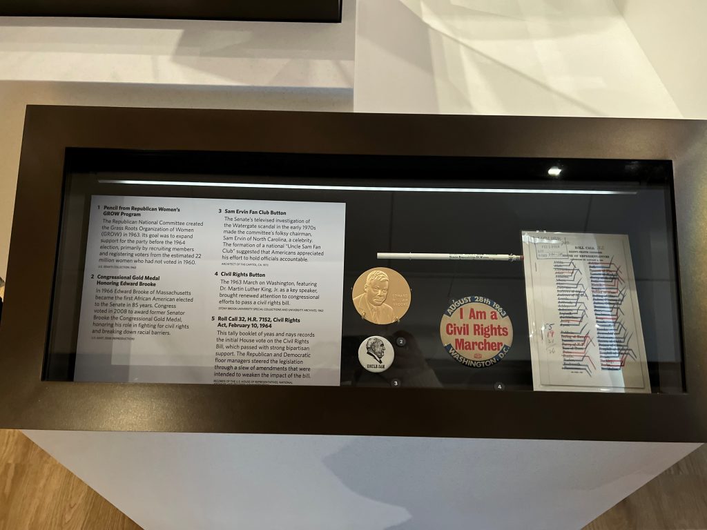 "I Am a Civil Rights Marcher" pin-back button on display at the U.S. Capitol Visitor Center, August 2022.  From the Nettie Feinberg Collection, Special Collections, SBU Libraries.