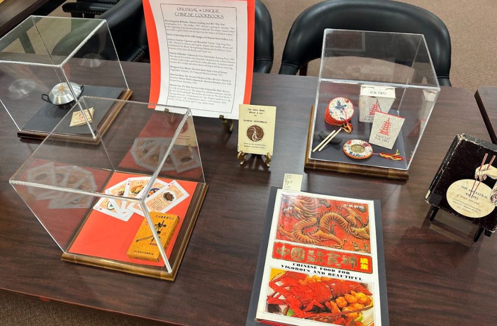 Photograph of books and artifacts about Chinese food and culture. Taken at the Art Crawl in Special Collections, Melville Library, Stony Brook University on April 26, 2023.