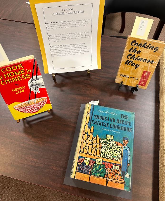 Photograph of three books about Chinese cooking. Taken at the Art Crawl in Special Collections, Melville Library, Stony Brook University on April 26, 2023.