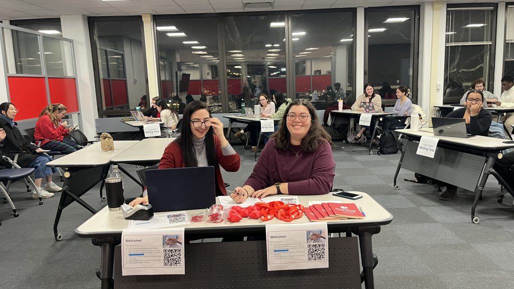 Two people sitting at a table smiling