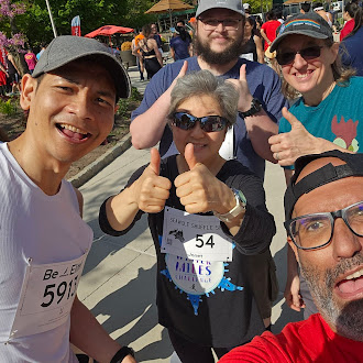 Group of runners smiling at camera.