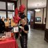 AI: woman holding balloons in front of red table labeled series (AI-generated alt-text)
