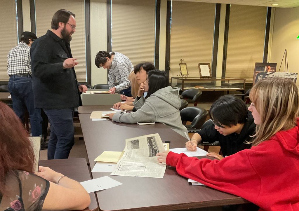 Students in Professor Sam Dodd's course ARH 400 consulting the Robert M. Emery Long Island Rail Road Collection in Special Collections, Stony Brook University Libraries, October 2025.