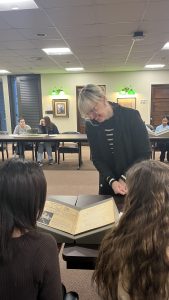 Students looking at a telephone directory from 1936.