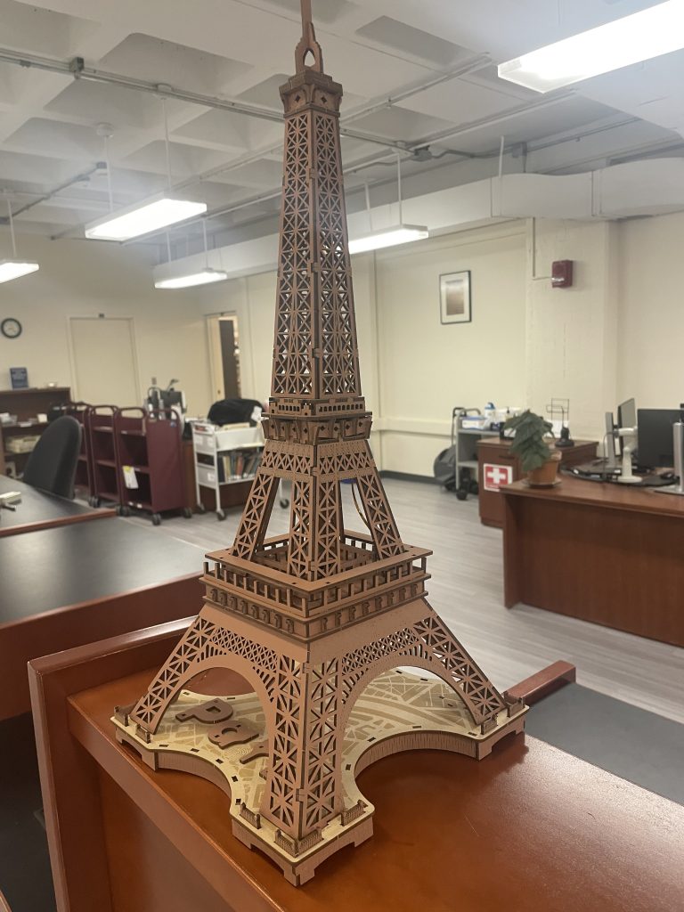 Picture of a miniature Eiffel Tower on the circulation desk in a library