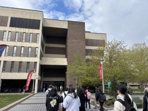 A group of students and faculty from the back, walking back to Melville Library